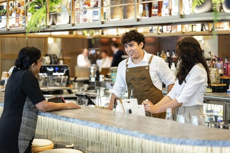 Colleague serving guests at the bar